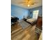 Bright bedroom featuring cool-toned walls, wood-look flooring, and a comfortable layout at 10411 Summerview Cir, Riverview, FL 33578