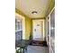 Covered front porch featuring a welcome mat, a table and a white front door at 10411 Summerview Cir, Riverview, FL 33578