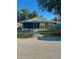 Charming single-story home with a green lawn and an enclosed front porch at 10411 Summerview Cir, Riverview, FL 33578