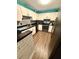 Modern kitchen with white cabinets, black countertops, and stainless steel appliances at 10411 Summerview Cir, Riverview, FL 33578