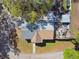 Aerial view of a single Gathering home with mature trees and a well-manicured lawn at 10501 Bay Hills Cir, Thonotosassa, FL 33592
