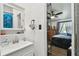 Bright bathroom with a white sink and cabinet that looks into a bedroom at 10501 Bay Hills Cir, Thonotosassa, FL 33592