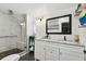 Bright bathroom featuring a glass-enclosed walk-in shower with a tiled bench and a double vanity at 10501 Bay Hills Cir, Thonotosassa, FL 33592