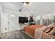 Comfortable bedroom featuring warm-toned bedding, neutral walls with decorative pictures, and a bright front entry at 10501 Bay Hills Cir, Thonotosassa, FL 33592