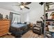 Comfortable bedroom featuring a ceiling fan, a recliner, hardwood floors, and a dresser at 10501 Bay Hills Cir, Thonotosassa, FL 33592