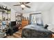 Bedroom featuring a ceiling fan, a dresser, hardwood floors, and large window at 10501 Bay Hills Cir, Thonotosassa, FL 33592