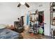 Cozy bedroom featuring a recliner, hardwood floors, closet, and shelving at 10501 Bay Hills Cir, Thonotosassa, FL 33592