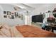 Cozy bedroom featuring warm-toned bedding, neutral walls with decorative pictures, and bright front entry at 10501 Bay Hills Cir, Thonotosassa, FL 33592