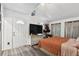 Cozy bedroom with a queen bed, TV, and a door leading outside at 10501 Bay Hills Cir, Thonotosassa, FL 33592