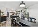 Open-concept dining room and kitchen area featuring a black wood table set and stylish decorations at 10501 Bay Hills Cir, Thonotosassa, FL 33592