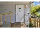 Charming front entrance features a white door with festive decorations and a small porch at 10501 Bay Hills Cir, Thonotosassa, FL 33592