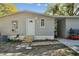 Exterior of home with a white front door and a small porch at 10501 Bay Hills Cir, Thonotosassa, FL 33592