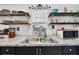 Close up of kitchen featuring granite countertops, double bowl sink, and open shelving at 10501 Bay Hills Cir, Thonotosassa, FL 33592