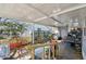 Covered patio area with furniture, lighting and exterior views offering ample space for relaxation and outdoor living at 10501 Bay Hills Cir, Thonotosassa, FL 33592