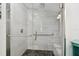 Walk-in shower featuring glass enclosure, tiled bench, black pebble flooring, and a rain shower head at 10501 Bay Hills Cir, Thonotosassa, FL 33592