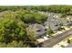 An aerial view showcases the community and the home's lush green surroundings at 10716 Ashford Oaks Dr, Tampa, FL 33625
