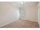Cozy bedroom with neutral carpet, a window with blinds, and closet at 10716 Ashford Oaks Dr, Tampa, FL 33625