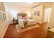 Comfortable bedroom featuring wood floors, neutral walls, and a plush rug at 10716 Ashford Oaks Dr, Tampa, FL 33625