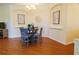 Cozy dining room features wood floors, stylish table setting, and elegant decor at 10716 Ashford Oaks Dr, Tampa, FL 33625