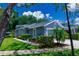 Charming exterior of a gray home featuring manicured landscaping and a well-maintained lawn at 10716 Ashford Oaks Dr, Tampa, FL 33625
