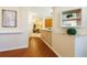 Hallway with wood floors and neutral walls connects the living spaces and kitchen at 10716 Ashford Oaks Dr, Tampa, FL 33625