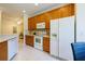 Well-maintained kitchen with wood cabinets, white appliances, and tile flooring at 10716 Ashford Oaks Dr, Tampa, FL 33625