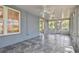 Covered lanai featuring gray tile floors, ceiling fans, and screens all around at 10716 Ashford Oaks Dr, Tampa, FL 33625