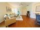 Bright living room features wood floors, comfortable seating, and sliding doors leading to the outside at 10716 Ashford Oaks Dr, Tampa, FL 33625
