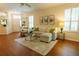 Inviting living room features wood floors, comfortable seating, and large windows at 10716 Ashford Oaks Dr, Tampa, FL 33625
