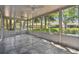 Enclosed patio with tiled flooring, ceiling fans, and great views of the property at 10716 Ashford Oaks Dr, Tampa, FL 33625