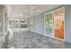 Enclosed patio with tiled flooring, ceiling fans, and a slider door entrance to the home at 10716 Ashford Oaks Dr, Tampa, FL 33625