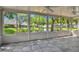 Relaxing sunroom with lake view, ceiling fans, and tile floors at 10716 Ashford Oaks Dr, Tampa, FL 33625