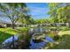 Scenic backyard pond view adds tranquility, enhancing this property's appeal at 10716 Ashford Oaks Dr, Tampa, FL 33625