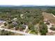 An aerial view of property shaded by mature trees, close to neighbors and bordering open land at 11207 Donneymoor Dr, Riverview, FL 33569