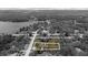 Monochrome aerial view emphasizing property location at 11207 Donnymoor Dr, Riverview, FL, near a lake and surrounded by trees at 11207 Donneymoor Dr, Riverview, FL 33569