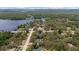 Aerial view of a home surrounded by mature trees and near a tranquil lake, offering serene waterfront living at 11207 Donneymoor Dr, Riverview, FL 33569