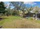Scenic backyard with a screened-in pool area, providing a perfect space for outdoor relaxation and entertainment at 11207 Donneymoor Dr, Riverview, FL 33569