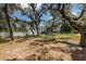 Large backyard featuring lush greenery, a white fence, and a glimpse of the home, perfect for outdoor enjoyment at 11207 Donneymoor Dr, Riverview, FL 33569