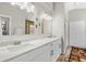 Bright bathroom features a double vanity with marble countertop and modern lighting fixtures at 11207 Donneymoor Dr, Riverview, FL 33569