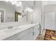 Bright bathroom features a double vanity with marble countertop and modern lighting fixtures at 11207 Donneymoor Dr, Riverview, FL 33569