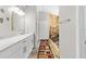 Spacious bathroom boasts a long vanity with marble countertop and a colorful runner at 11207 Donneymoor Dr, Riverview, FL 33569