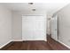 Bedroom with hardwood flooring, a spacious closet, and neutral paint providing a clean feel at 11207 Donneymoor Dr, Riverview, FL 33569
