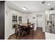 Cozy dining area with wood table, seating for four, and next to stainless steel fridge at 11207 Donneymoor Dr, Riverview, FL 33569