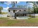 The backyard offers a screened-in pool, covered patio, lush landscaping, and solar panels on the roof at 11207 Donneymoor Dr, Riverview, FL 33569