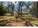 Charming two-story home featuring a brick chimney, solar panels, mature trees, and a well-manicured lawn at 11207 Donneymoor Dr, Riverview, FL 33569