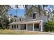 Two-story home featuring dormer windows, a brick facade, and a covered front porch at 11207 Donneymoor Dr, Riverview, FL 33569