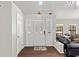 Bright foyer featuring beautiful flooring, decorative doors with sidelights, and an open view of the living area at 11207 Donneymoor Dr, Riverview, FL 33569