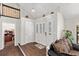 Spacious foyer with rich hardwood floors, decorative doors, and a view of the staircase and upper level at 11207 Donneymoor Dr, Riverview, FL 33569
