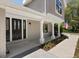 Welcoming front entrance featuring black double doors, white columns, and manicured landscaping at 11207 Donneymoor Dr, Riverview, FL 33569