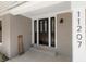 Inviting entryway with a unique door and sidelight design, a modern house number, and a 'hello' sign at 11207 Donneymoor Dr, Riverview, FL 33569